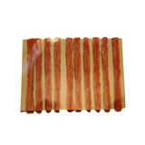 Orange bike brake pads on cardboard backing for mountain biking