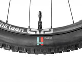Mopo Flux GR mountain bike tire on Thirteen wheel with tubeless valve, rugged tread for trail riding