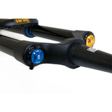 Black mountain bike suspension fork with blue LSC dial and gold adjustment knob, close-up detail
