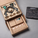 SRAM brake kit with green calipers, cables, and accessories in organized packaging