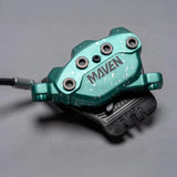 Teal Maven bike brake caliper with speckled design and black brake pads